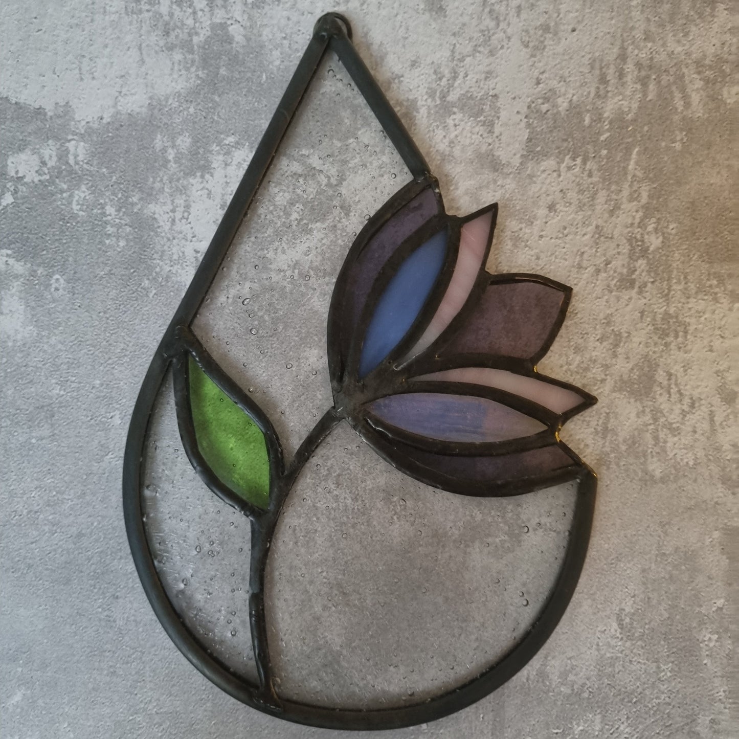 Stained glass tulip decoration on a textured gray background