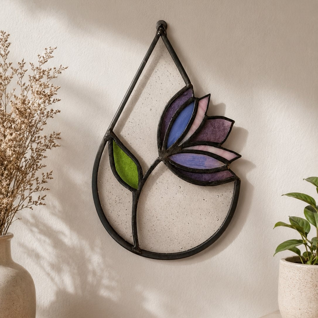 Decorative wall art with colorful leaf design on a plain wall.