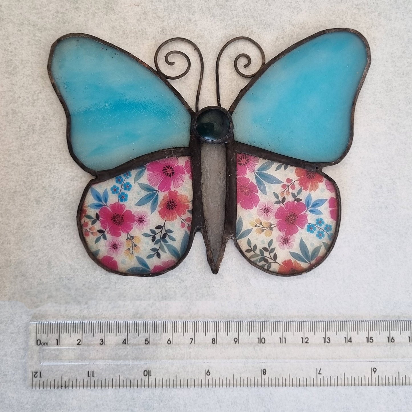 Azure blue stained glass butterfly – side view with flower details