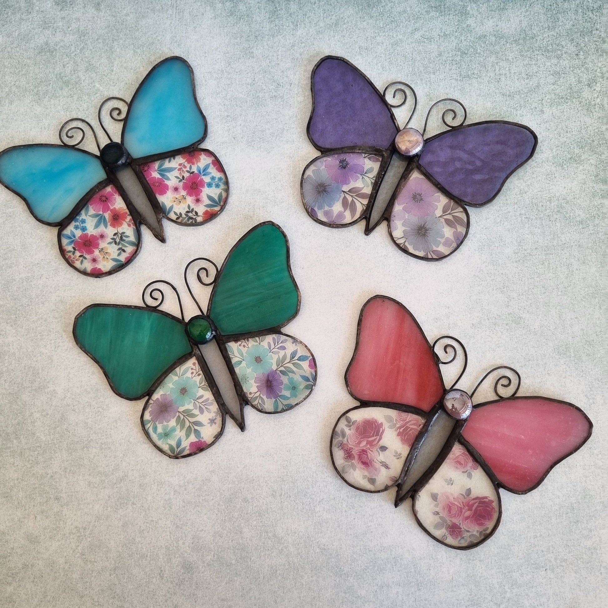 Collection of handmade glass butterflies in multiple colors