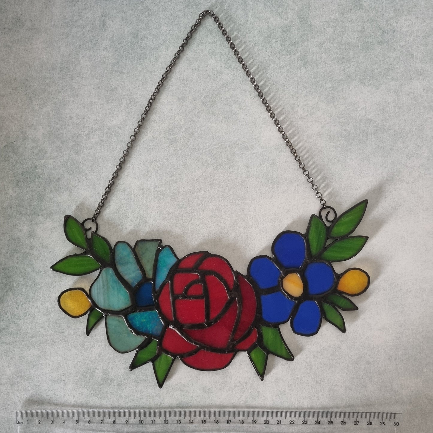 Stained glass flowers on a chain – close up of individual flowers