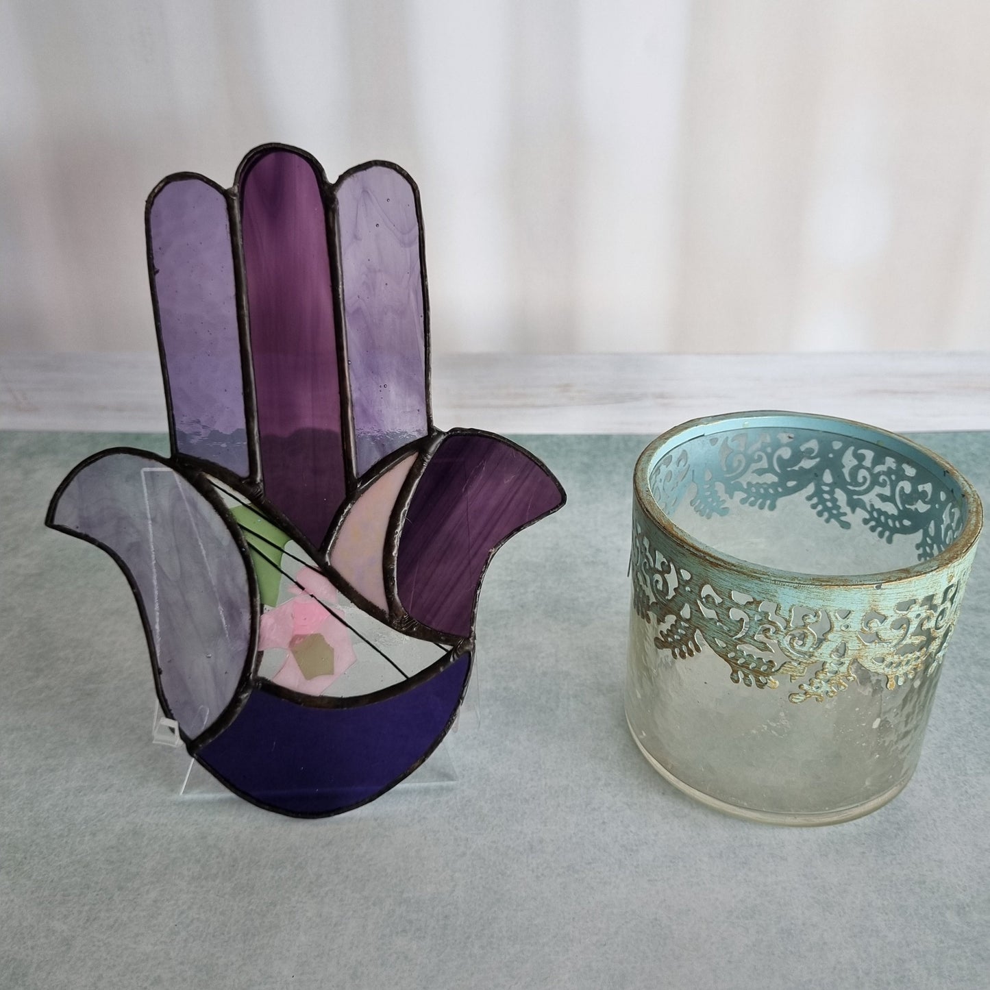 A purple glass Hamsa suncatcher 