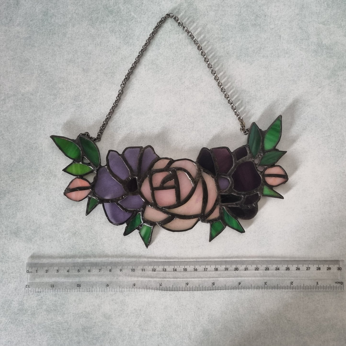 Purple stained glass flowers on a chain – close up detail