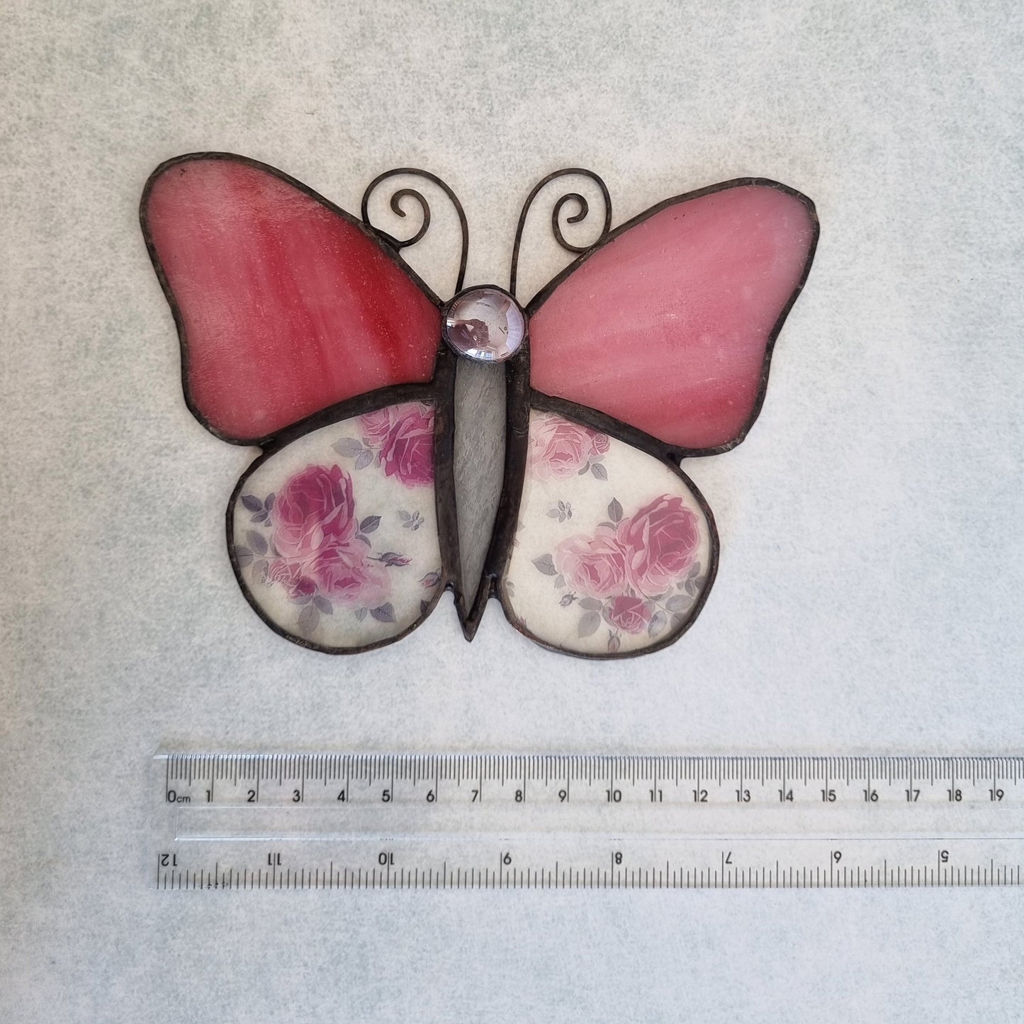 Pink stained glass butterfly – side view with flower details