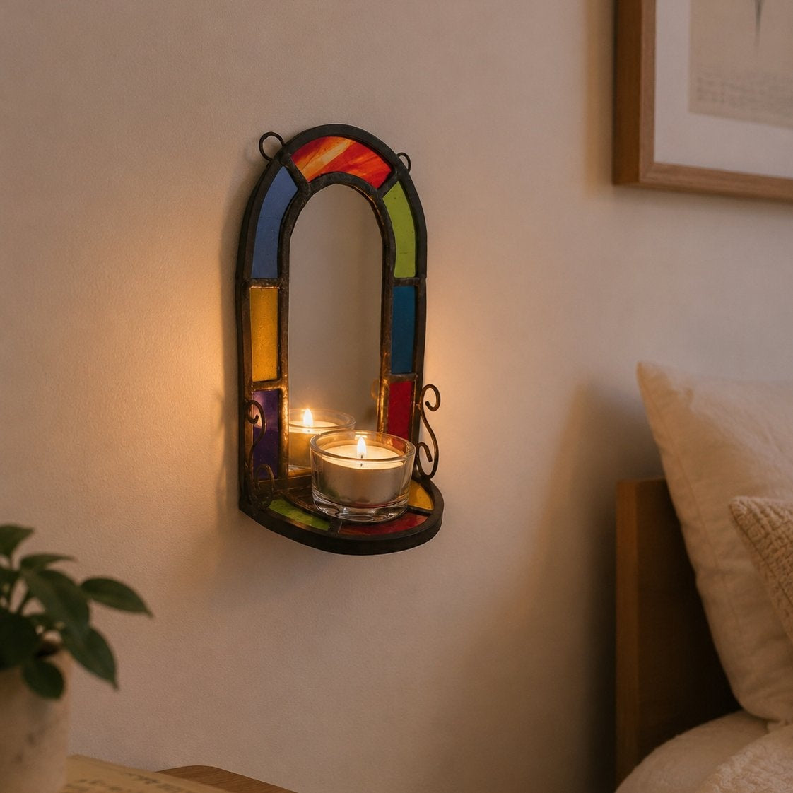 Decorative wall mirror with colorful stained glass design holding a candle in a cozy room.